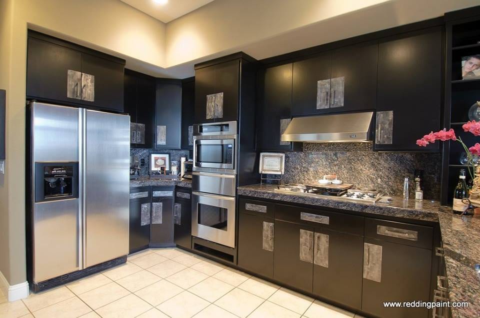 Deep charcoal kitchen cabinets with stainless appliances