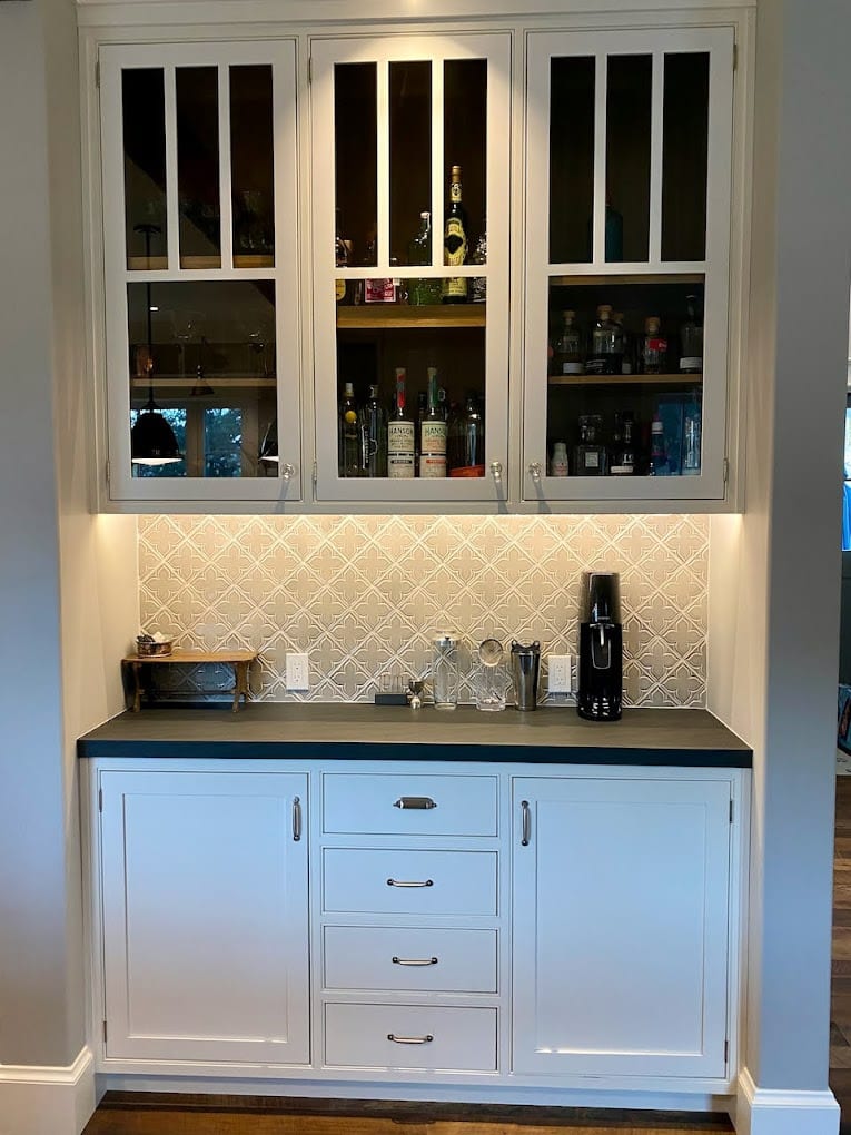 Soft blue-grey cabinets with white tile backsplash