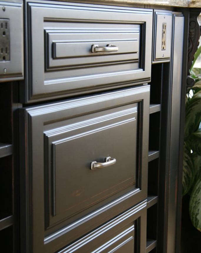 Detail of a refinished cabinet drawer front and hardware