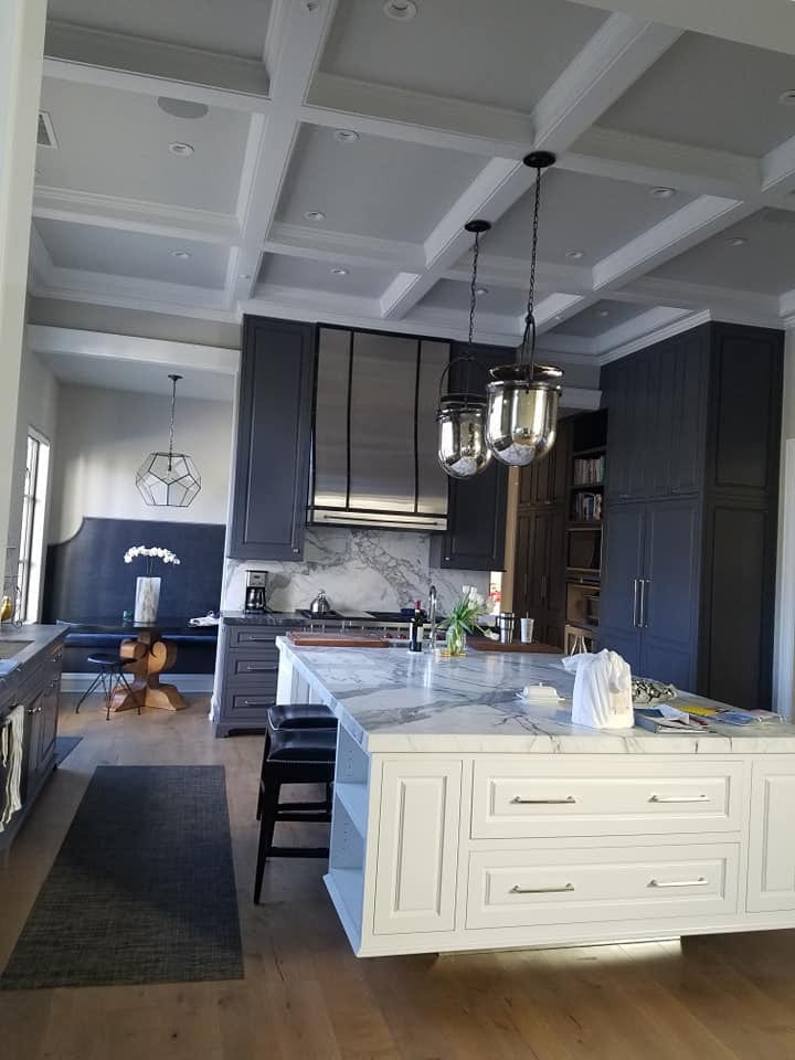 Navy and white kitchen with brass hardware and marble
