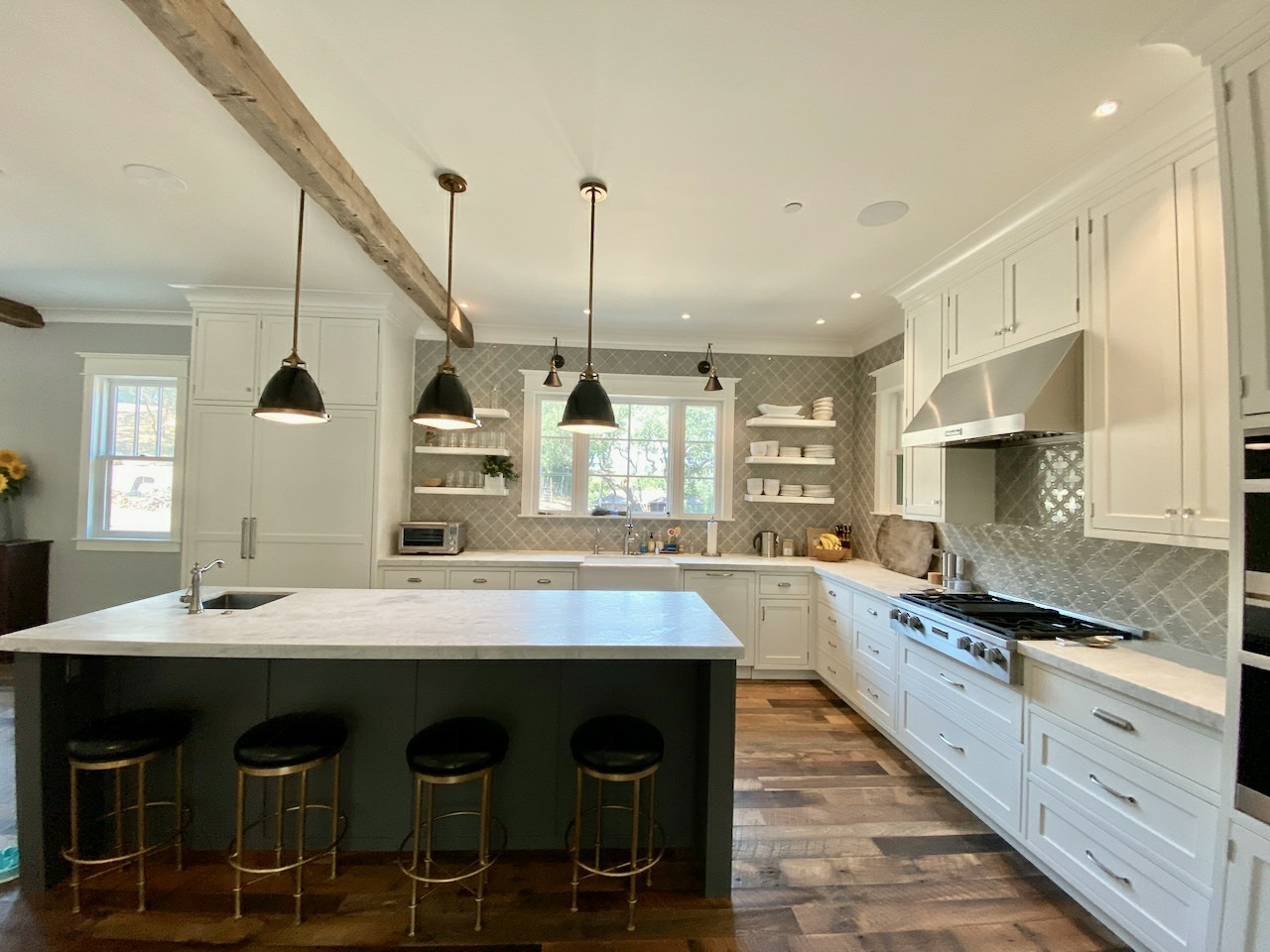 Refinished white kitchen with a dark-green island